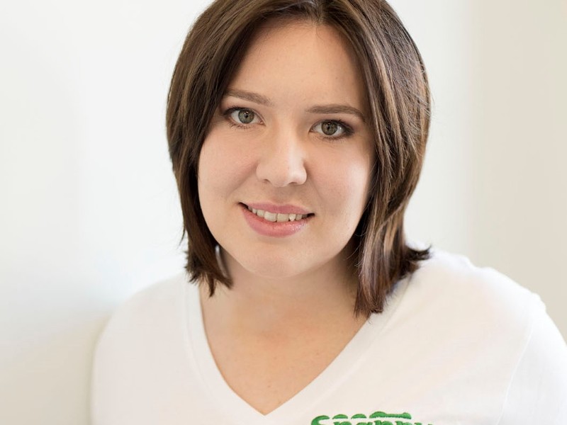 Image of Katie Haggath looking Snappy in her Snappy Communication t-shirt. It's got a green logo that spells out Snappy Communication. The S looks like the tail of a crocodile.
